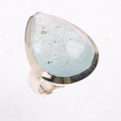 2522 - A large sterling silver aquamarine dress ring, set with pear cabochon aquamarine, setting height 28.... 