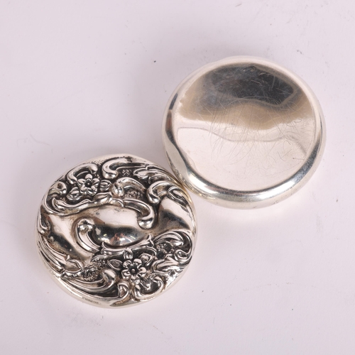 2697 - An Art Nouveau Edwardian silver pillbox, Jones & Crompton Birmingham 1909, circular form with relief... 