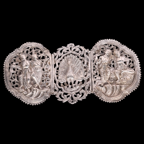 2699 - A large Indian silver nurse's buckle, relief embossed decoration depicting peacock and dancing figur... 