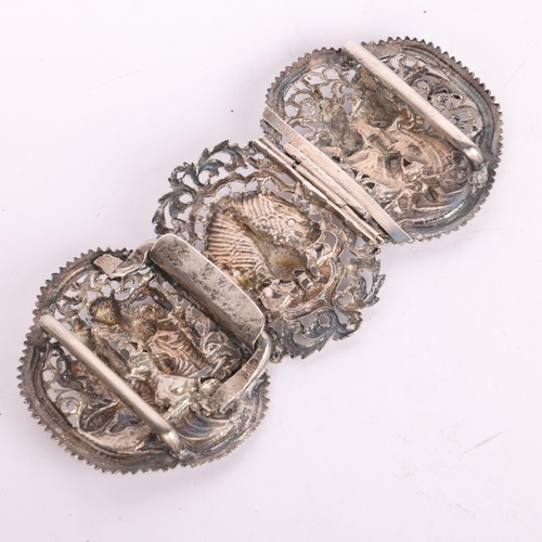 2699 - A large Indian silver nurse's buckle, relief embossed decoration depicting peacock and dancing figur... 