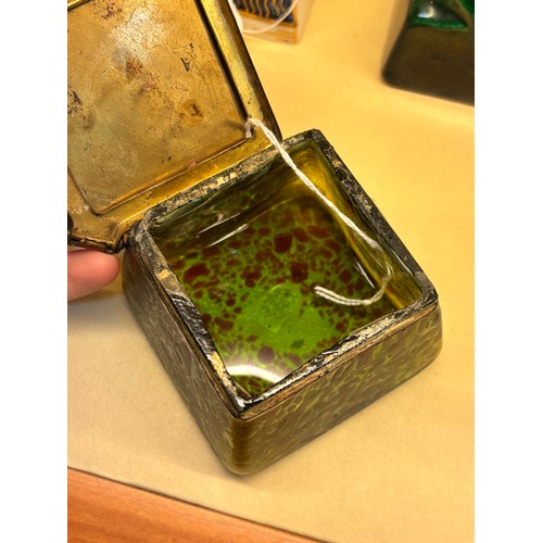 36 - Loetz iridescent green glass box, hinged brass cover with impressed holly leaf design, width 7.5cm