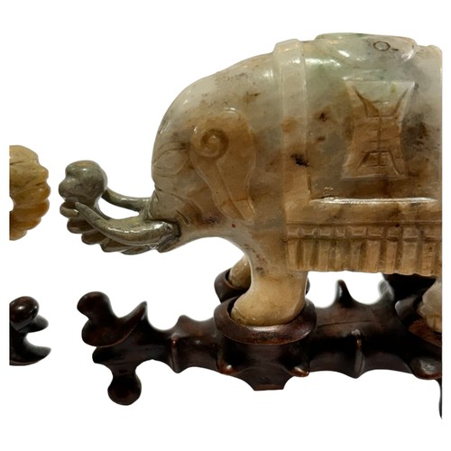 865 - A pair of small Chinese carved jade elephants on carved wood stands, length 10.5cm