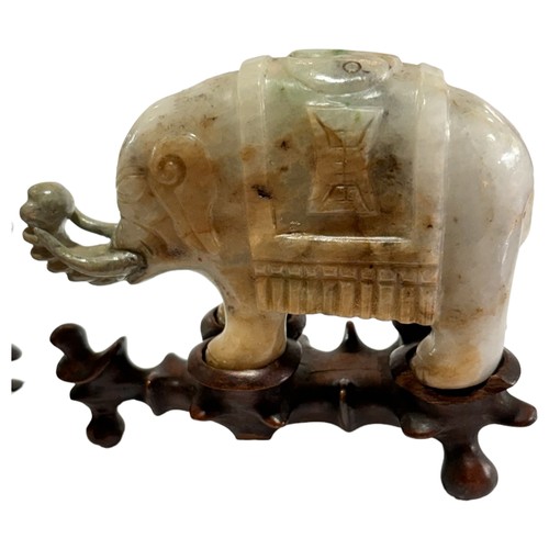 865 - A pair of small Chinese carved jade elephants on carved wood stands, length 10.5cm