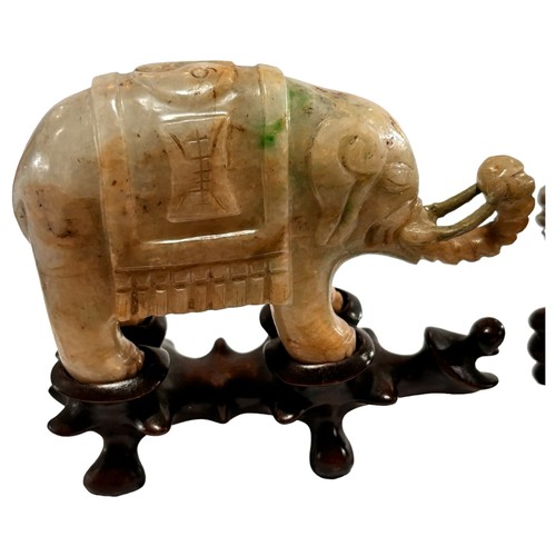 865 - A pair of small Chinese carved jade elephants on carved wood stands, length 10.5cm