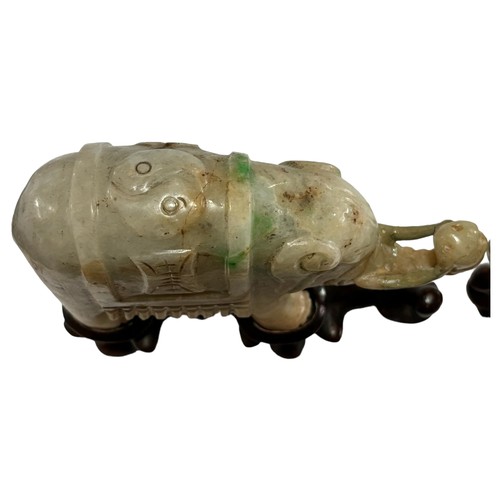 865 - A pair of small Chinese carved jade elephants on carved wood stands, length 10.5cm