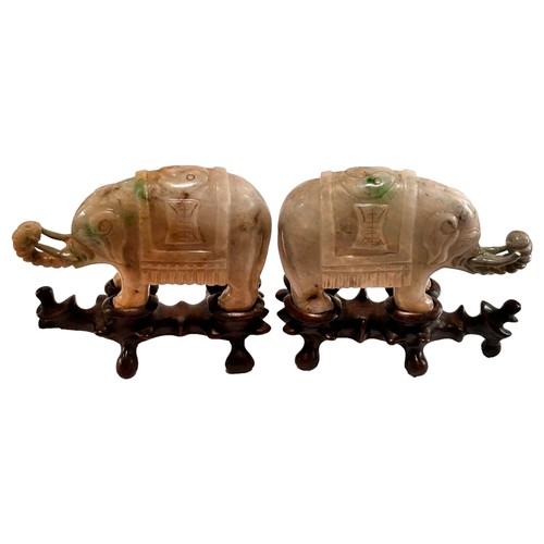 865 - A pair of small Chinese carved jade elephants on carved wood stands, length 10.5cm