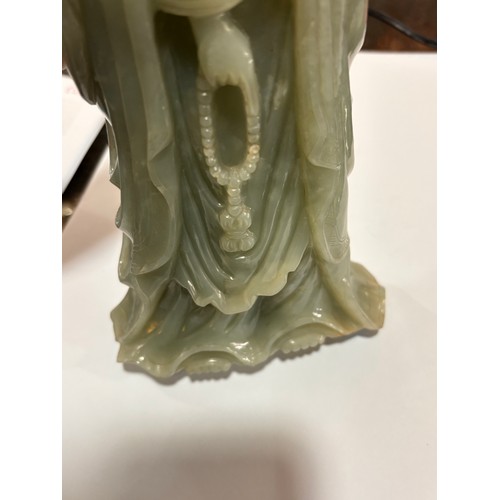 782 - A Chinese carved green jade figure of Guanyin on carved hardwood stand, overall height 32cm, provena... 