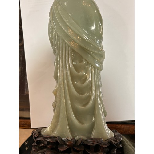 782 - A Chinese carved green jade figure of Guanyin on carved hardwood stand, overall height 32cm, provena... 