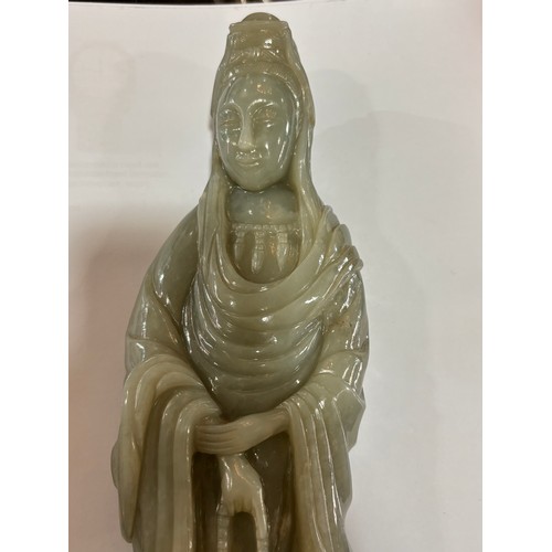 782 - A Chinese carved green jade figure of Guanyin on carved hardwood stand, overall height 32cm, provena... 