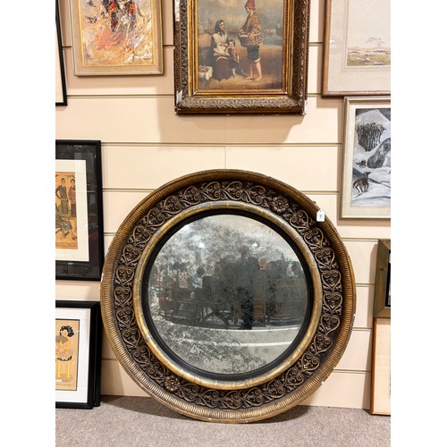 891 - A large Georgian convex mirror, with gilded relief carved wood and gesso surround, original oxidised... 