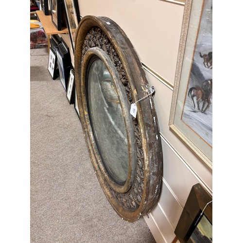 891 - A large Georgian convex mirror, with gilded relief carved wood and gesso surround, original oxidised... 