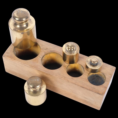 34 - A graduated set of Continental bronze apothecary weights, in fitted stand