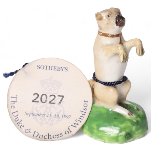 1 - An early 19th century English porcelain figure of a begging Pug dog, with pale tan coat, black muzzl... 