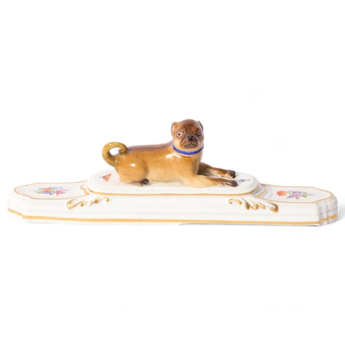 12 - A 19th century porcelain Pug paperweight, on stepped plinth base, a gold and blue collar with gilded... 
