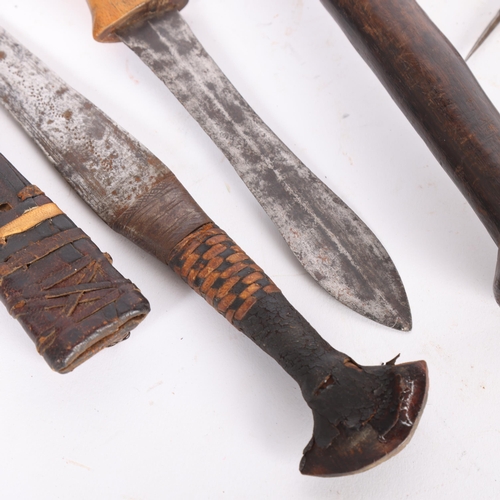 125 - A group of African tools and knives, including a carving adze, a leather sheathed knife, Congo knife... 