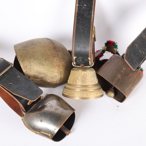 132 - 4 large souvenir Swiss cow bells, on leather straps
