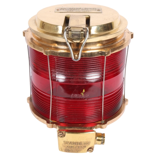 167 - Tranberg, a brass-cased ship's lantern with red glass body, dated 1977, All-Round/Rundt, 28cm