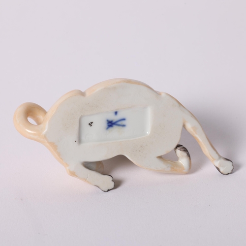 2 - Meissen, a porcelain figure of a seated Pug looking backwards, with a blue and gilded studded collar... 