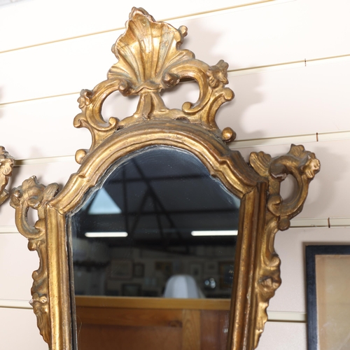 217 - A pair of Antique giltwood and gesso framed shield-shaped wall mirrors, with acanthus leaf pediments... 