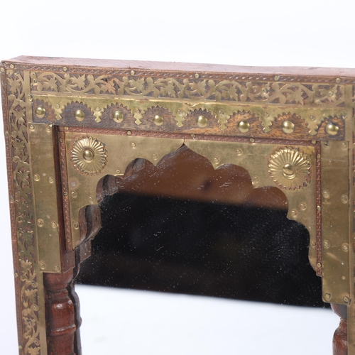 219 - A Moorish design rectangular wall mirror, wood-framed with applied scrolled and pierced brass decora... 