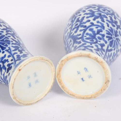 245 - 2 similar Chinese blue and white baluster vases, floral decoration, both stamped to the underside wi... 