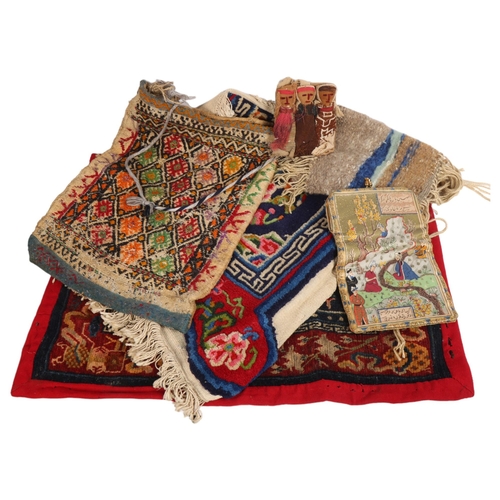 280 - A selection of Ethnic textiles, to include various Persian rugs, largest 70cm x 53cm, a camel bag wi... 