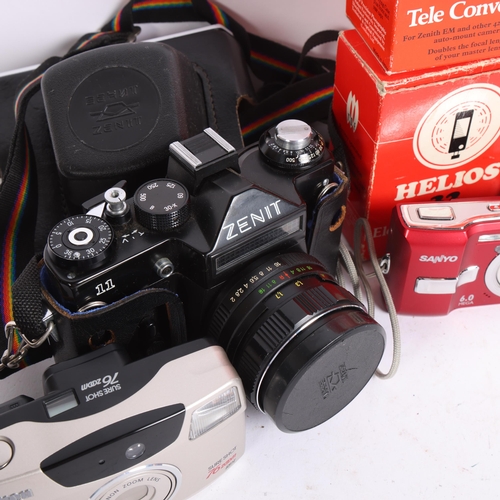 310 - A selection of Vintage cameras and associated accessories, including a Zenit 11, a Hanimex 110F pock... 