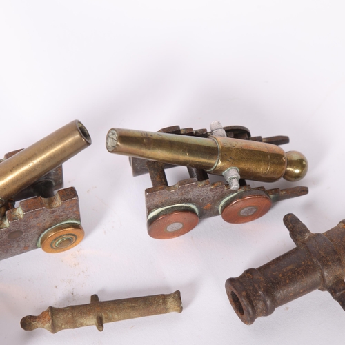 46 - A pair of cast brass and steel cannons on stands, 2 steel cannons, and another