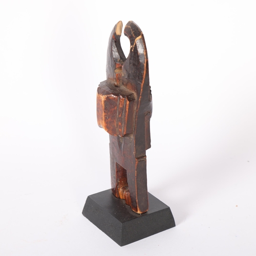 48 - A Baule, Ivory Coast weaving pulley, carved wood masked figure on wooden plinth, height 16cm