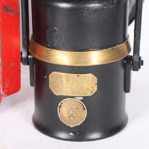 558 - A Crestella Premier railway oil lantern, and a red painted London Transport lantern, initialled LT, ... 