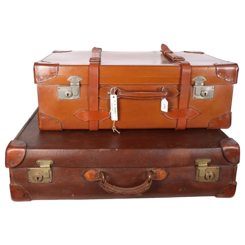 577 - Early 20th century leather travelling trunk, with straps, 71cm across, and another case, initialled ... 