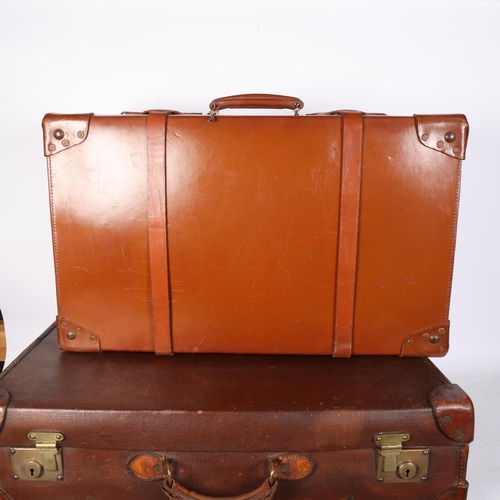 577 - Early 20th century leather travelling trunk, with straps, 71cm across, and another case, initialled ... 