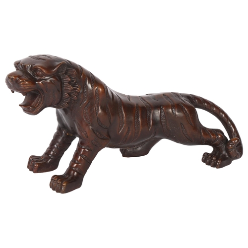 596 - Cast-bronze study of a tiger, L35cm