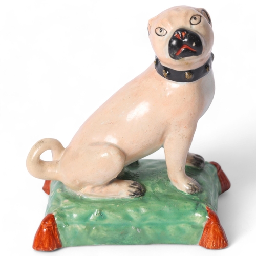 6 - Derby, a 19th century study of a Pug, on a painted cushion base, with a painted black collar, H9.5cm