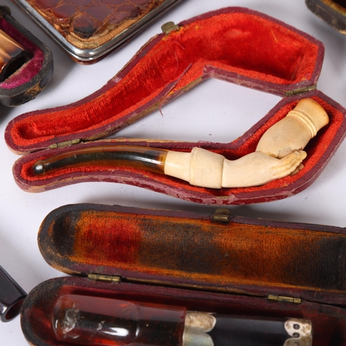 74 - A collection of various cigarette holders, including amber and silver-mounted, a small Meerschaum pi... 