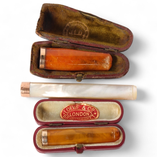 78 - A large mother-of-pearl and 15ct gold mounted cigarette holder, and 2 amber and 9ct gold mounted cig... 