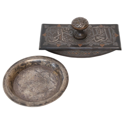 79 - A Cairo Ware desk blotter, and a Persian silver circular dish with engraved decoration (2)