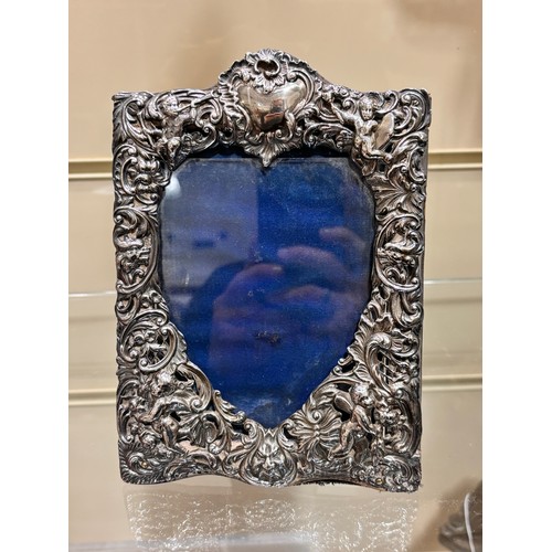 2705 - A pair of late Victorian silver-fronted heart photo frames, William Comyns, London 1892, relief embo... 