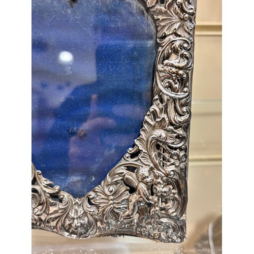 2705 - A pair of late Victorian silver-fronted heart photo frames, William Comyns, London 1892, relief embo... 