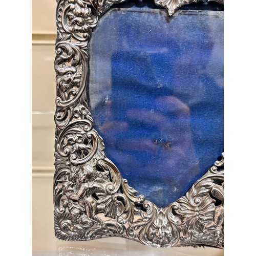 2705 - A pair of late Victorian silver-fronted heart photo frames, William Comyns, London 1892, relief embo... 