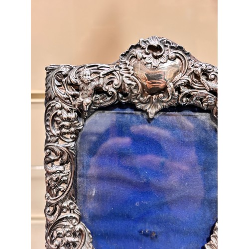 2705 - A pair of late Victorian silver-fronted heart photo frames, William Comyns, London 1892, relief embo... 