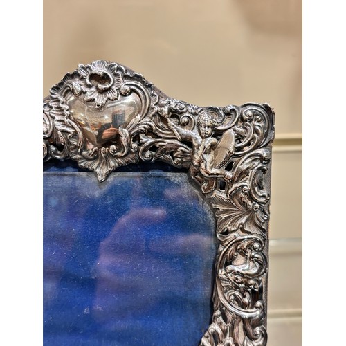 2705 - A pair of late Victorian silver-fronted heart photo frames, William Comyns, London 1892, relief embo... 