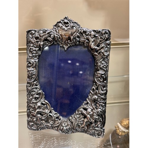 2705 - A pair of late Victorian silver-fronted heart photo frames, William Comyns, London 1892, relief embo... 