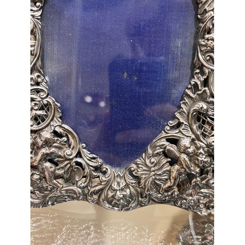 2705 - A pair of late Victorian silver-fronted heart photo frames, William Comyns, London 1892, relief embo... 