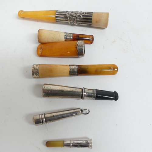 76 - A group of silver-mounted cigar/cigarette holders, including amber and silver, 4 boxed examples, and... 