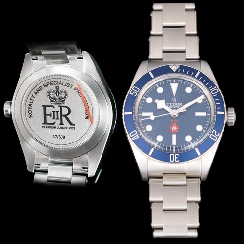 TUDOR - a rare limited edition stainless steel Black Bay 58 'Platinum Jubilee RaSP' automatic bracelet watch, made for the Royalty & Specialist Protection Unit ref 79030B, date purchased 20th May 2022, blue dial with RaSP logo of an English rose with a crown, luminous dot hour markers with baton quarters, silvered outer minute divisions, luminous polished snowflake hands, sweep centre seconds hand, blue calibrated bezel insert with presentation engraving on caseback 'E II R', a reference to Queen Elizabeth II, the personal warrant number, limited edition no. 1*/300, on Tudor brushed stainless steel rivet style bracelet with signed folding clasp, serial no. 3WD1832, 27 jewel movement with calibre MT5402, case width 39mm, working order, boxed with papers, and 3 RaSP Challenge coins: 1x RaSP, 1x King Charles III Coronation and 1x Queen's Coronation.  Notes: this watch was specially made in a limited edition of 300 pieces for the Royalty & Specialist Protection Unit.  The commemorates Queen Elizabeth II's Platinum Jubilee in 2022.  The Unit provides close protection to the members of the Royal Family, Government Ministers including the Prime Minister and visiting Heads of State.  The watch is in unworn condition.