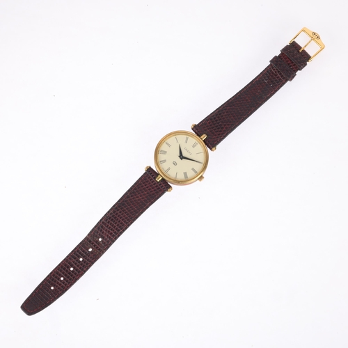 1021 - GUCCI - a gold plated quartz wristwatch, circa 1990, cream dial with Roman numeral hour markers, obe... 