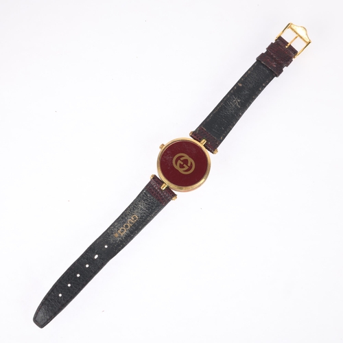 1021 - GUCCI - a gold plated quartz wristwatch, circa 1990, cream dial with Roman numeral hour markers, obe... 