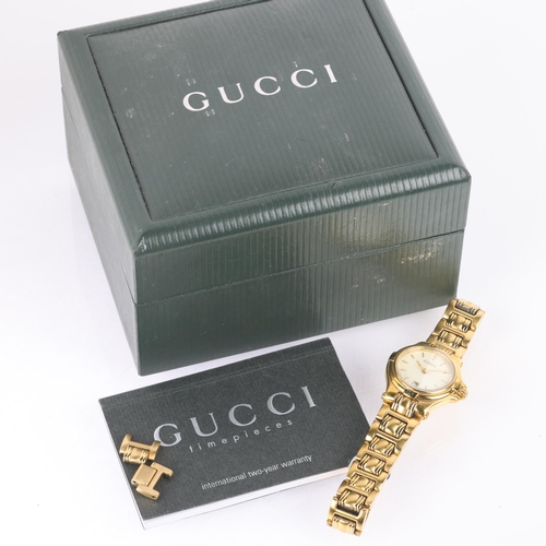 1029 - GUCCI - a lady's gold plated 9240L quartz bracelet watch, cream dial with gilt baton hour markers, p... 