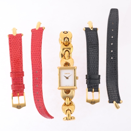 1030 - GUCCI - a lady's gold plated 1800L quartz bracelet watch, circa 1996, white dial with gilt lance han... 